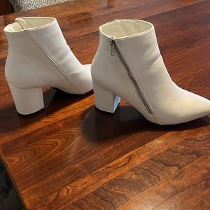 White faux leather boots.